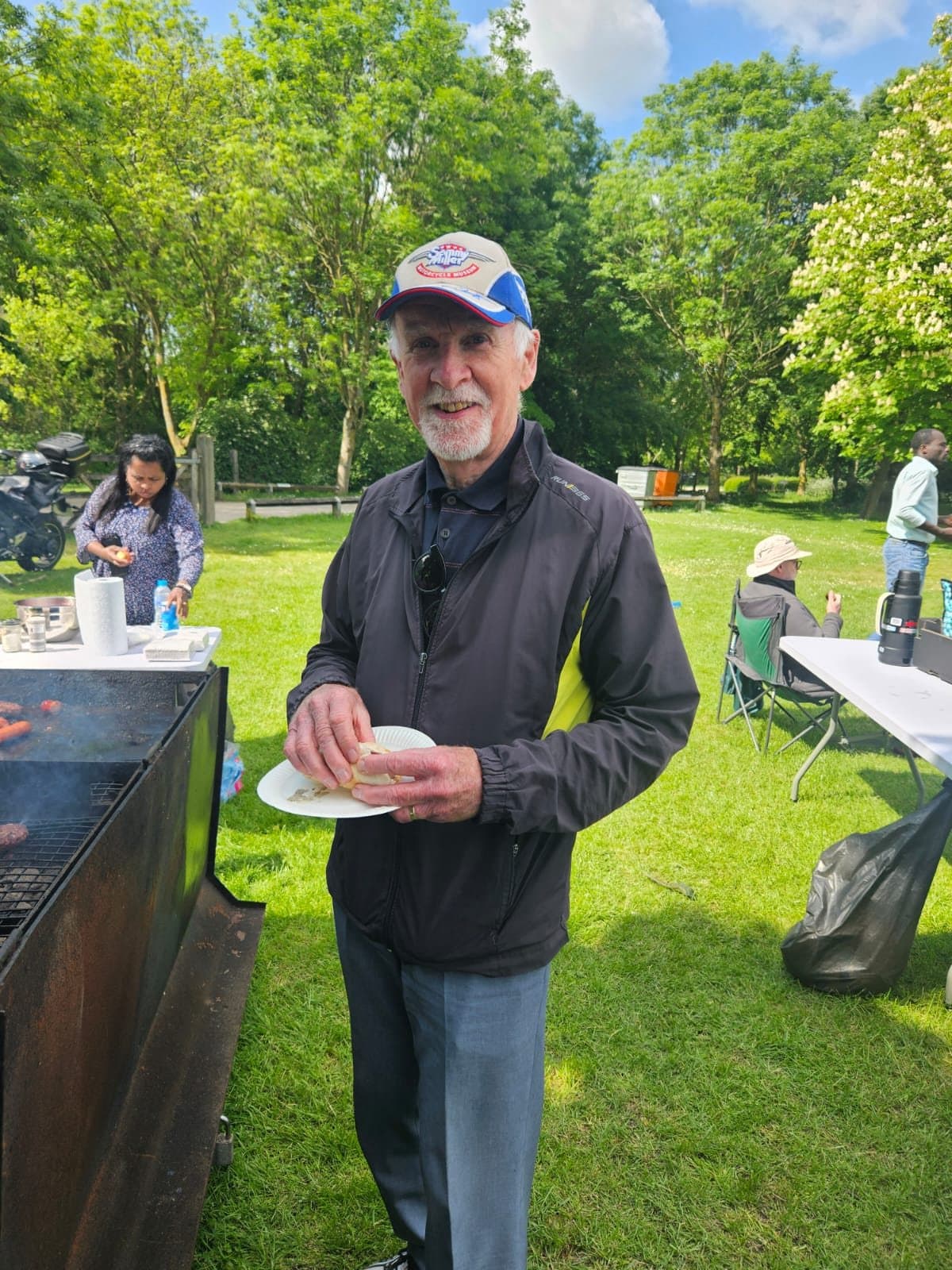 Pastor Malcolm enjoying food from the barbecue at the church picnic in the park